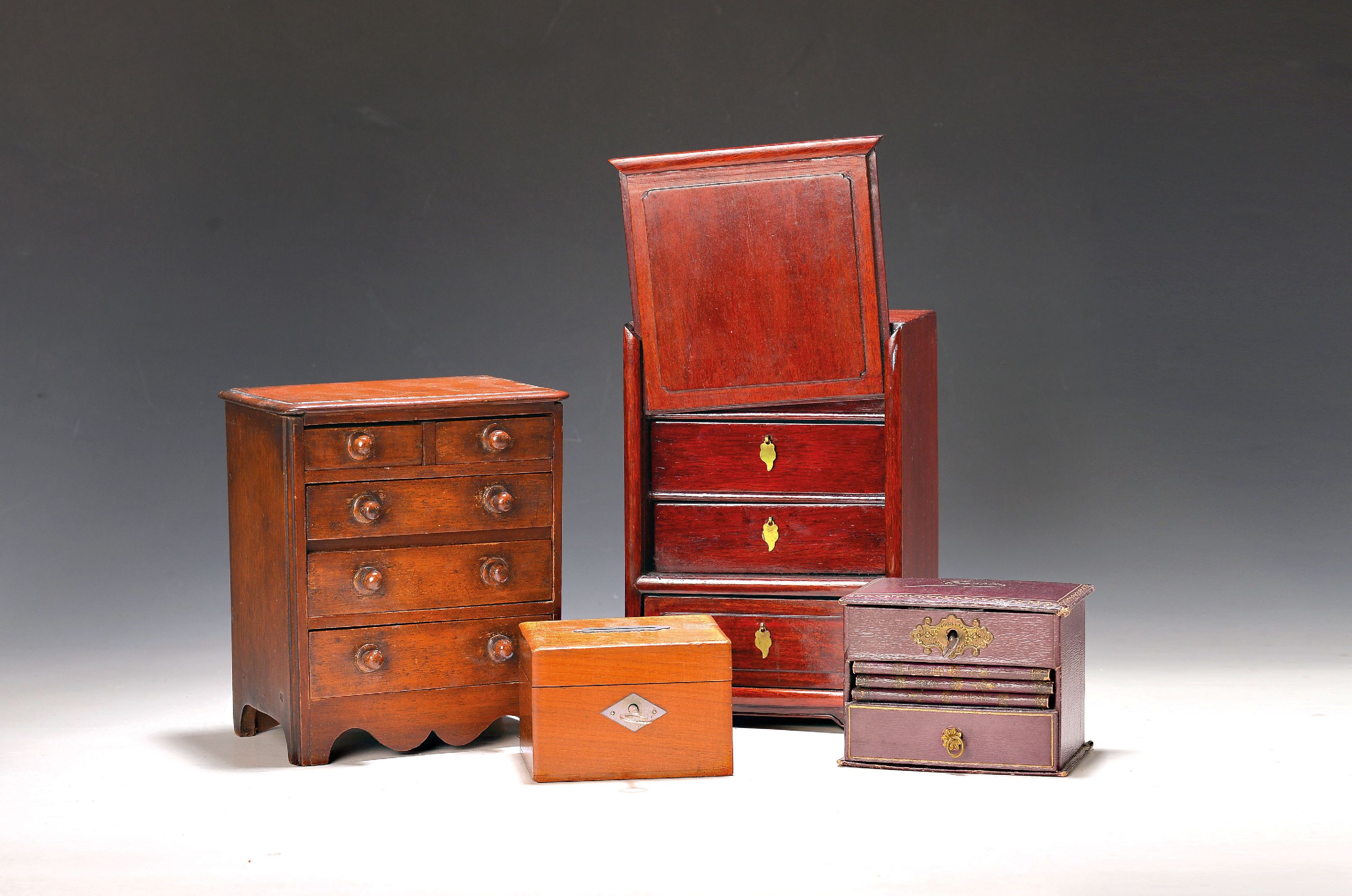 Zwei Modellmöbel, Sparkasse und kl. Schatulle, Ende 19. und 20. Jh., Modellkommode, mit 6 Schubladen, um 1880, Mahagoni, ca. 15.5x16x10 cm, ...