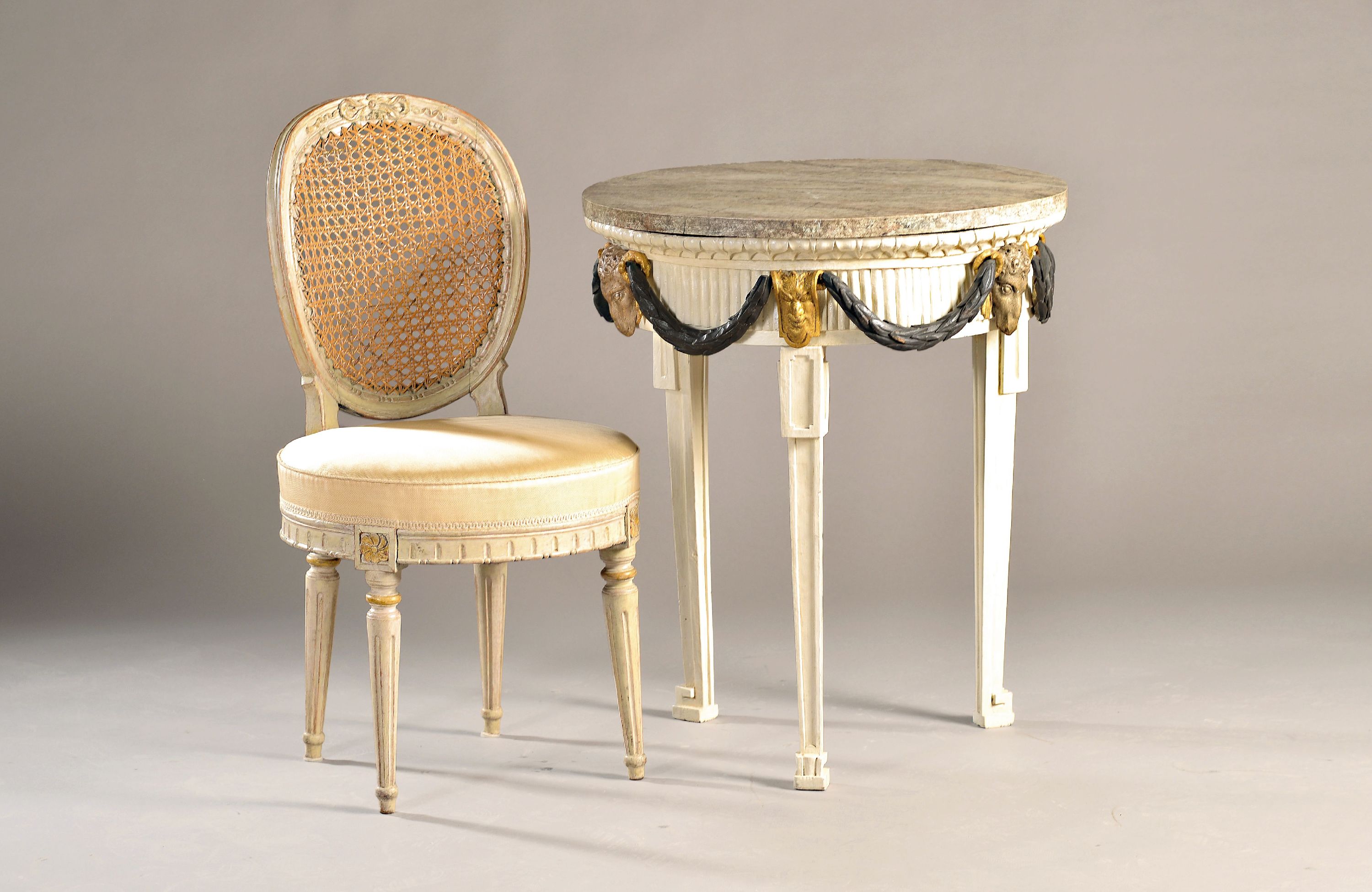 Runder Salontisch mit 2 Stühlen, norddeutsch, um 1800, Fichte, weiß gefasst, plastischer Dekor aus Widderköpfen und Festons, Holztischplatte in ...