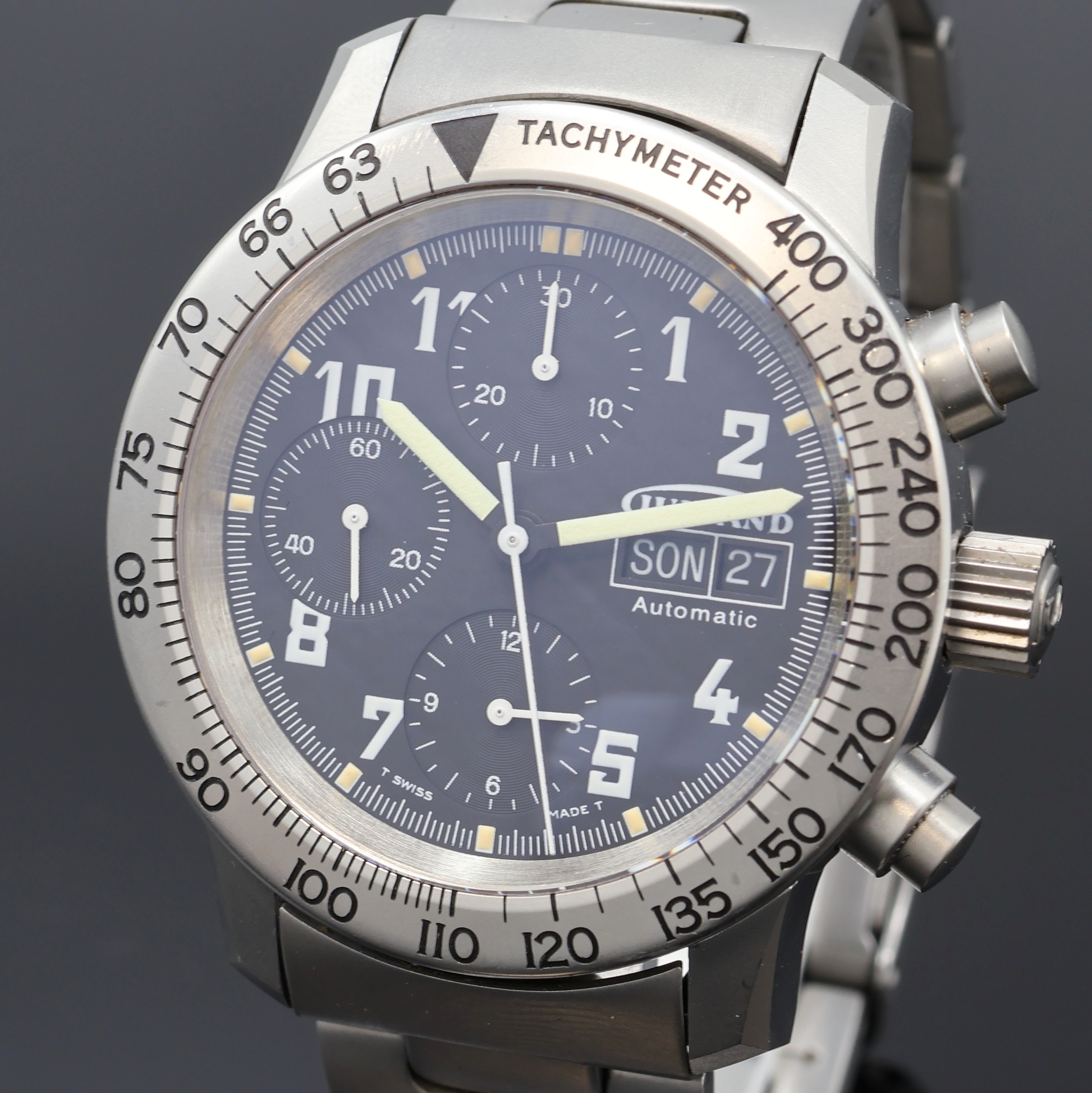 Detail a: GUINAND Armbandchronograph in Stahl/Stahlband, Schweiz um 1995, Automatik, beids. vergl. Geh., Boden u. Krone verschr., drehb. Tachymeter-Lünette, ...