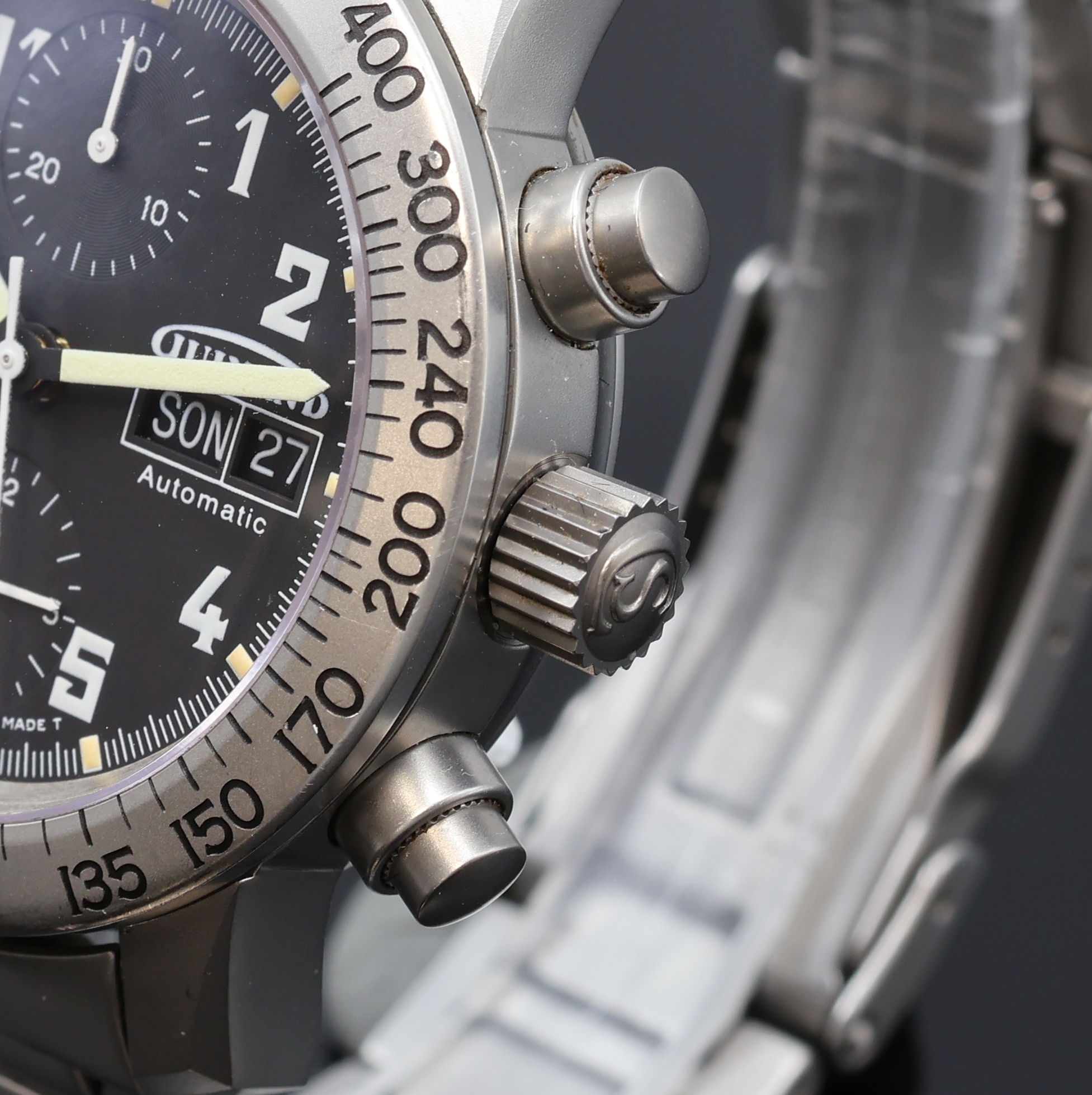 Detail b: GUINAND Armbandchronograph in Stahl/Stahlband, Schweiz um 1995, Automatik, beids. vergl. Geh., Boden u. Krone verschr., drehb. Tachymeter-Lünette, ...