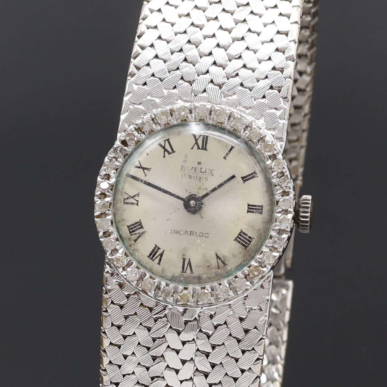 Detail a: EVELIX Damenarmbanduhr in WG 750/000 mit Diamantlünette, Handaufzug, Schweiz 1960er Jahre, Boden aufgedr., silb. Zifferbl. altersbed. fl./pat., ...