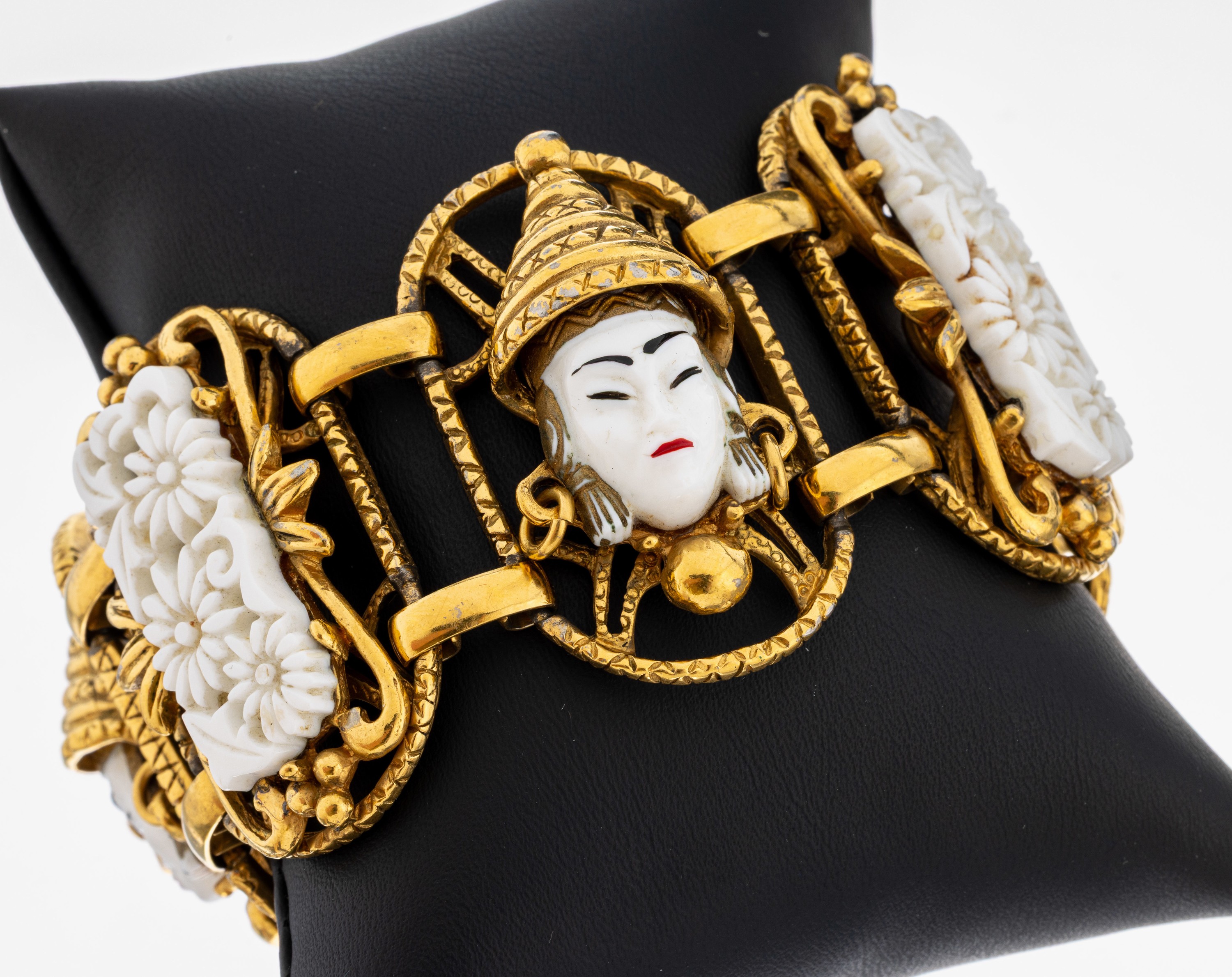 Image 27079073 - Bracelet, France, 1940s-50s , metal gold plated, Asian faces and floral motives, white ...