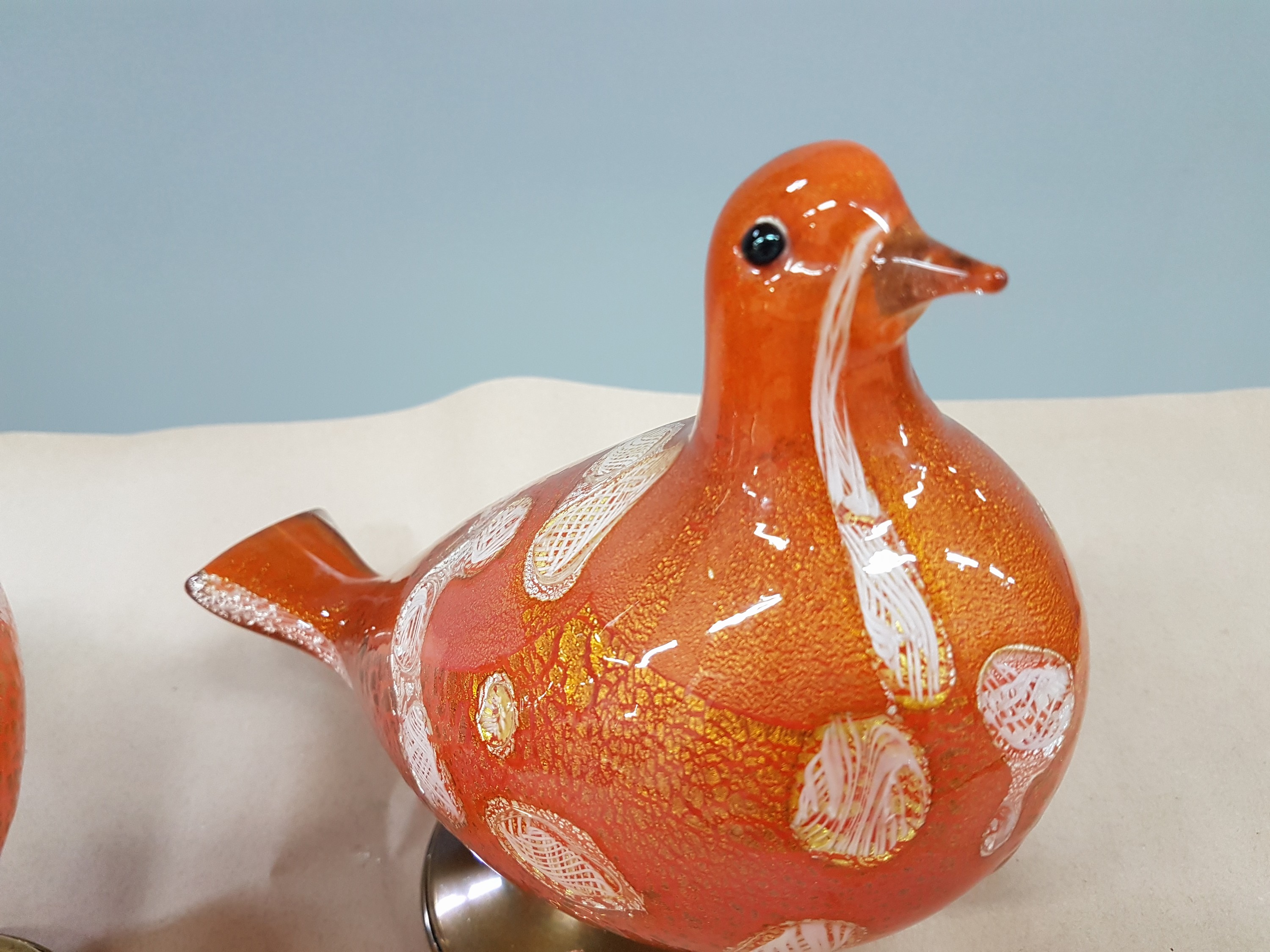 Detail f: Paar Glasskulpturen, Murano, 20. Jh., Taubenpaar, mundgeblasenes Glas mit roten, orangeroten und weißen Einschmelzungen, Goldpuder, Messingfüße, ...