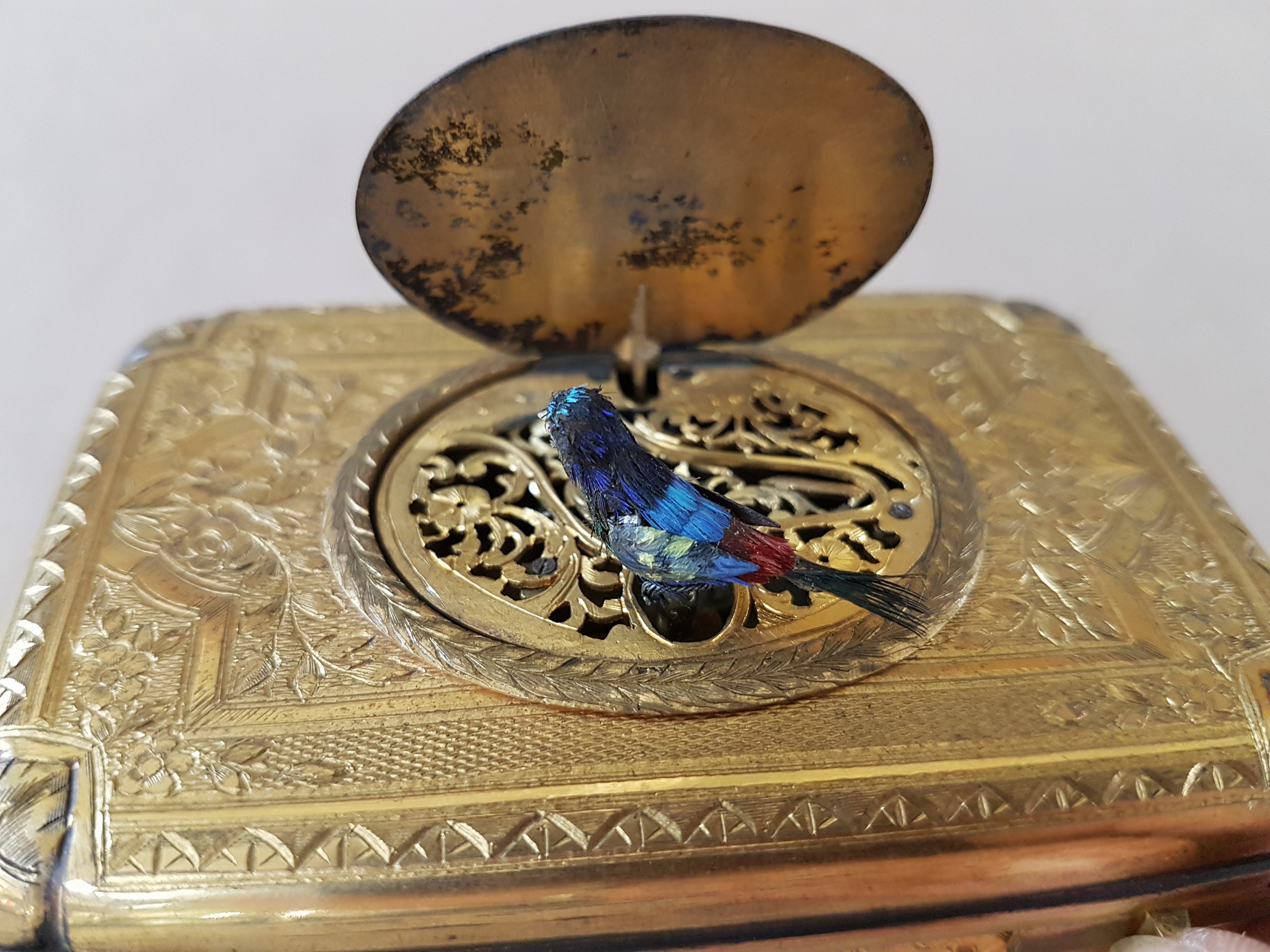 Detail h: Feine Singvogel-Spieldose, wohl Schweiz, um 1840, Metallgehäuse qualitätvoll vergoldet, graviert und guillochiert mit flächigem Dekor aus ...