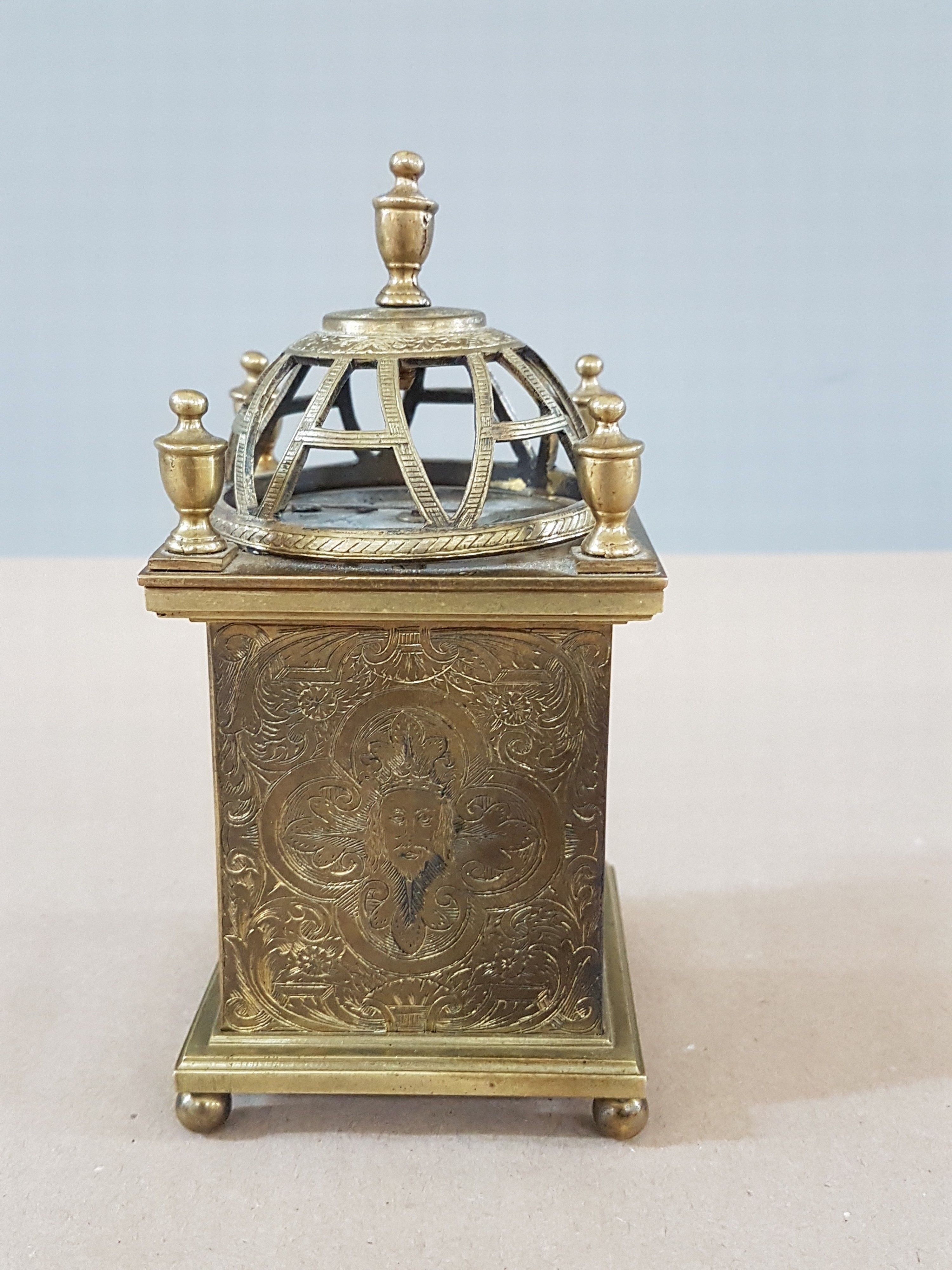 Detail d: Laternenuhr im Stil des 17.Jh., Ausführung wohl 20.Jh., Messinggehäuse, reich graviert, ornamental-floraler Dekor, rückseitiges Christusbild bzw. ...