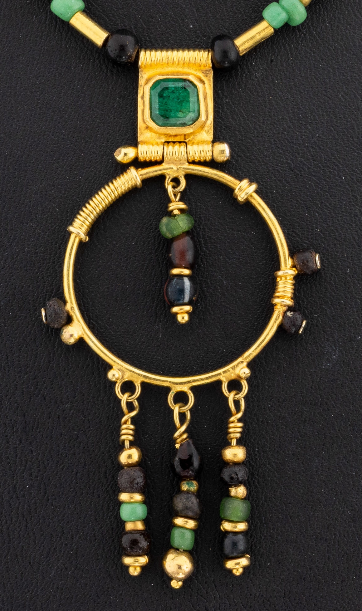 Detail a: 18 kt Gold Farbstein-Collier, GG 750/000 gepr., ungewöhnliches Design, rundes Mittelteil mit bewegl. Abhängungen, Smaragde und Lavagestein, 1 ...