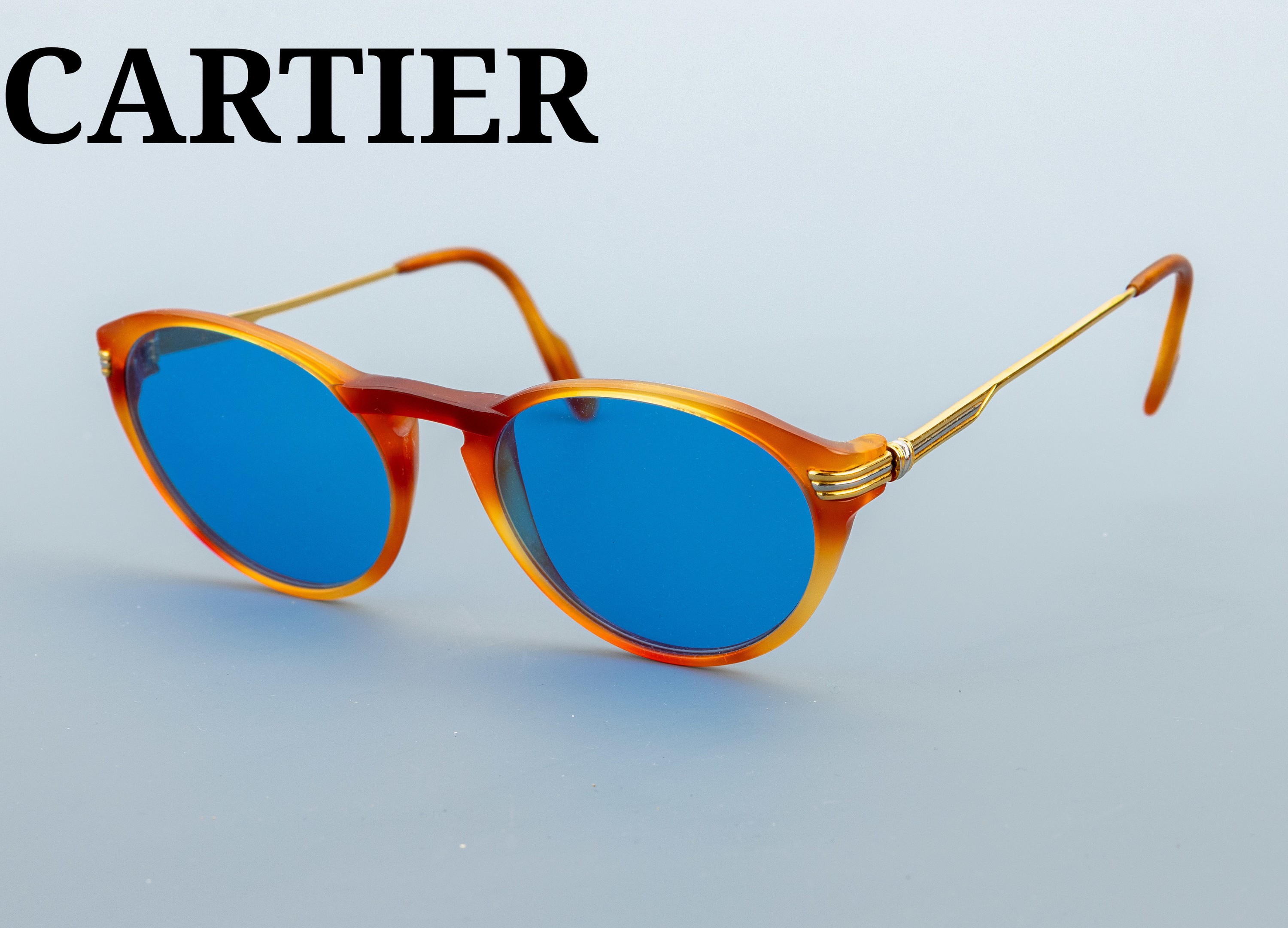 Image 27136262 - CARTIER Sonnenbrille, Metall verg., bernsteinfarb. Gestell, blau getönte Gläser, ...